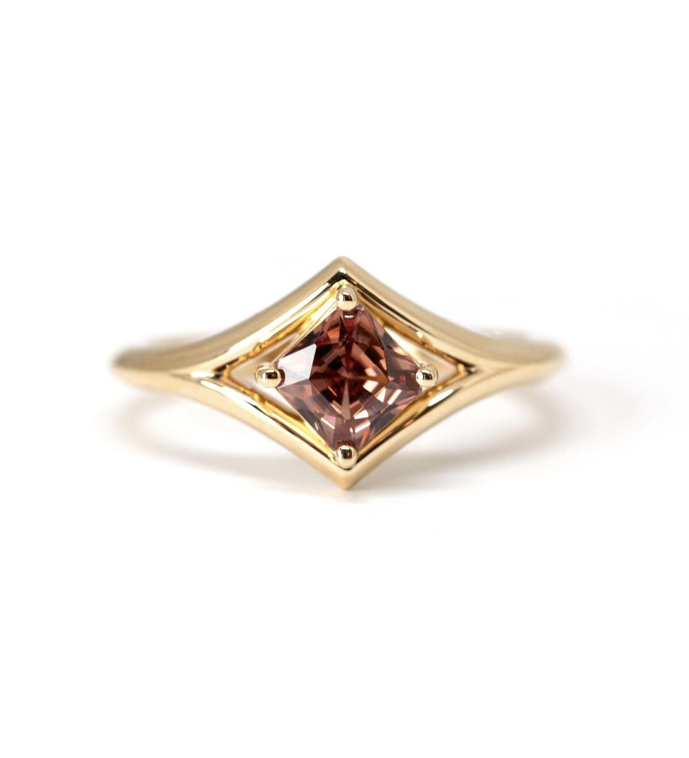 Front view: The Asscher Peach Zircon Ring in yellow gold, showcasing the Asscher-cut peach zircon’s precise geometric facets and its warm hues. Designed by Bena Jewelry in Montreal, Canada.