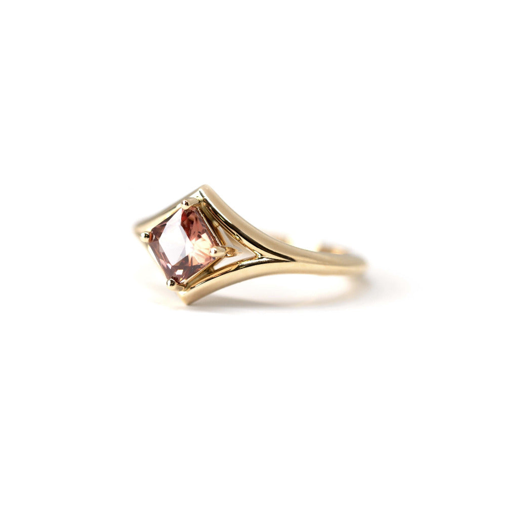 Side view: Highlights the depth of the peach zircon and the clean lines of the yellow gold setting, crafted in Montreal, Canada, by Bena Jewelry.