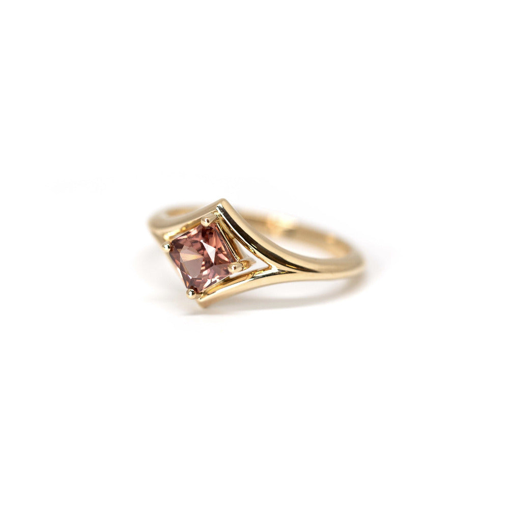 Top-down view: A clear perspective of the peach zircon’s Asscher cut, surrounded by the polished yellow gold band. Custom-made by Bena Jewelry, Montreal, Canada.