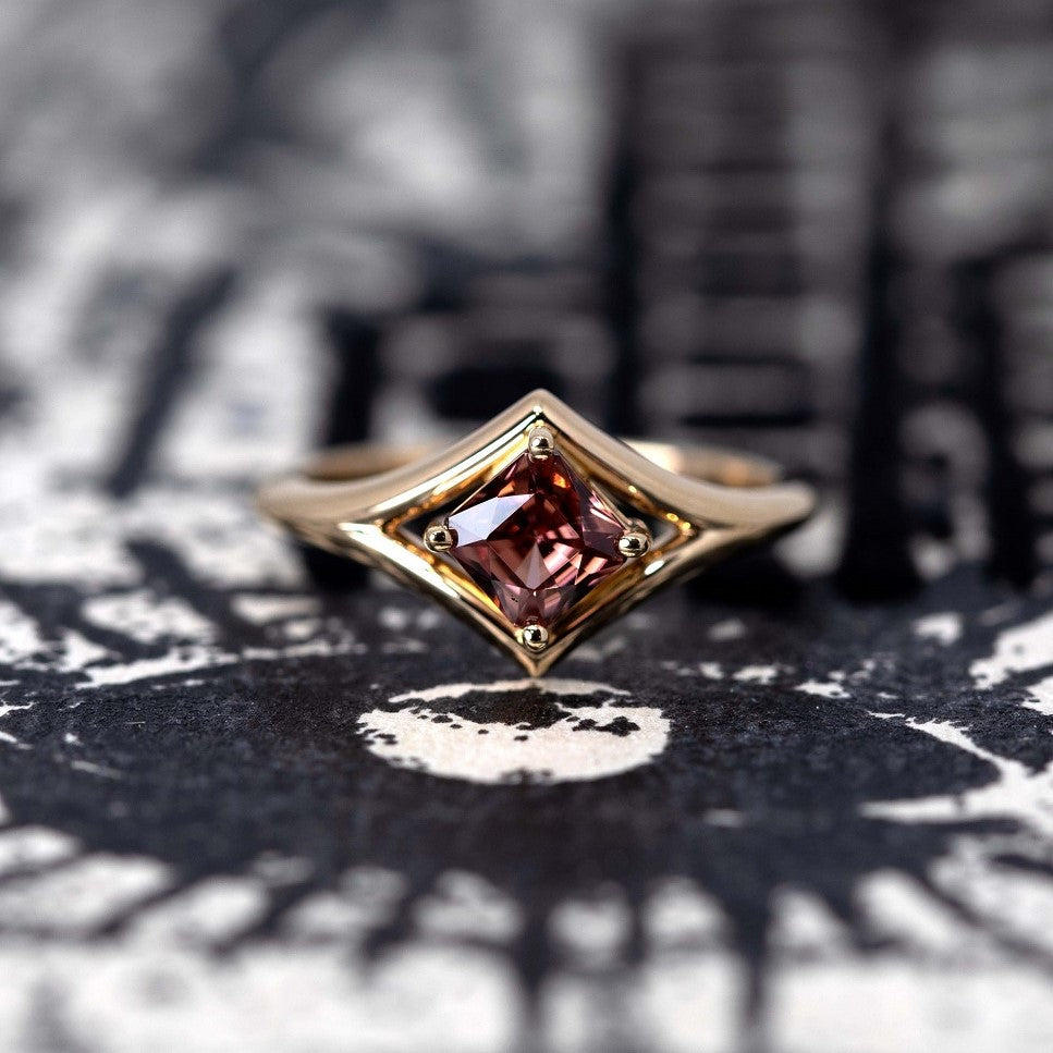 Front view: The Asscher Peach Zircon Ring in yellow gold, showcasing the Asscher-cut peach zircon’s precise geometric facets and its warm hues. Designed by Bena Jewelry in Montreal, Canada.