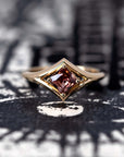 Front view: The Asscher Peach Zircon Ring in yellow gold, showcasing the Asscher-cut peach zircon’s precise geometric facets and its warm hues. Designed by Bena Jewelry in Montreal, Canada.