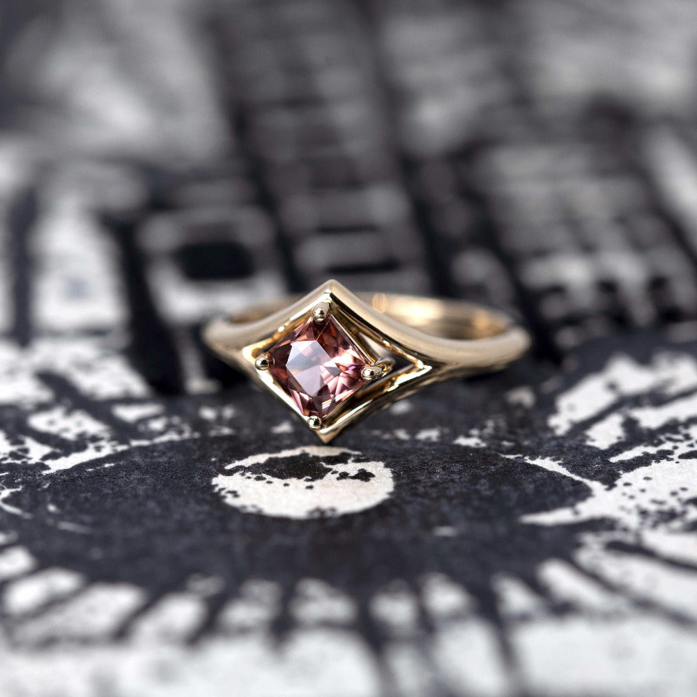 Top-down view: A clear perspective of the peach zircon’s Asscher cut, surrounded by the polished yellow gold band. Custom-made by Bena Jewelry, Montreal, Canada.