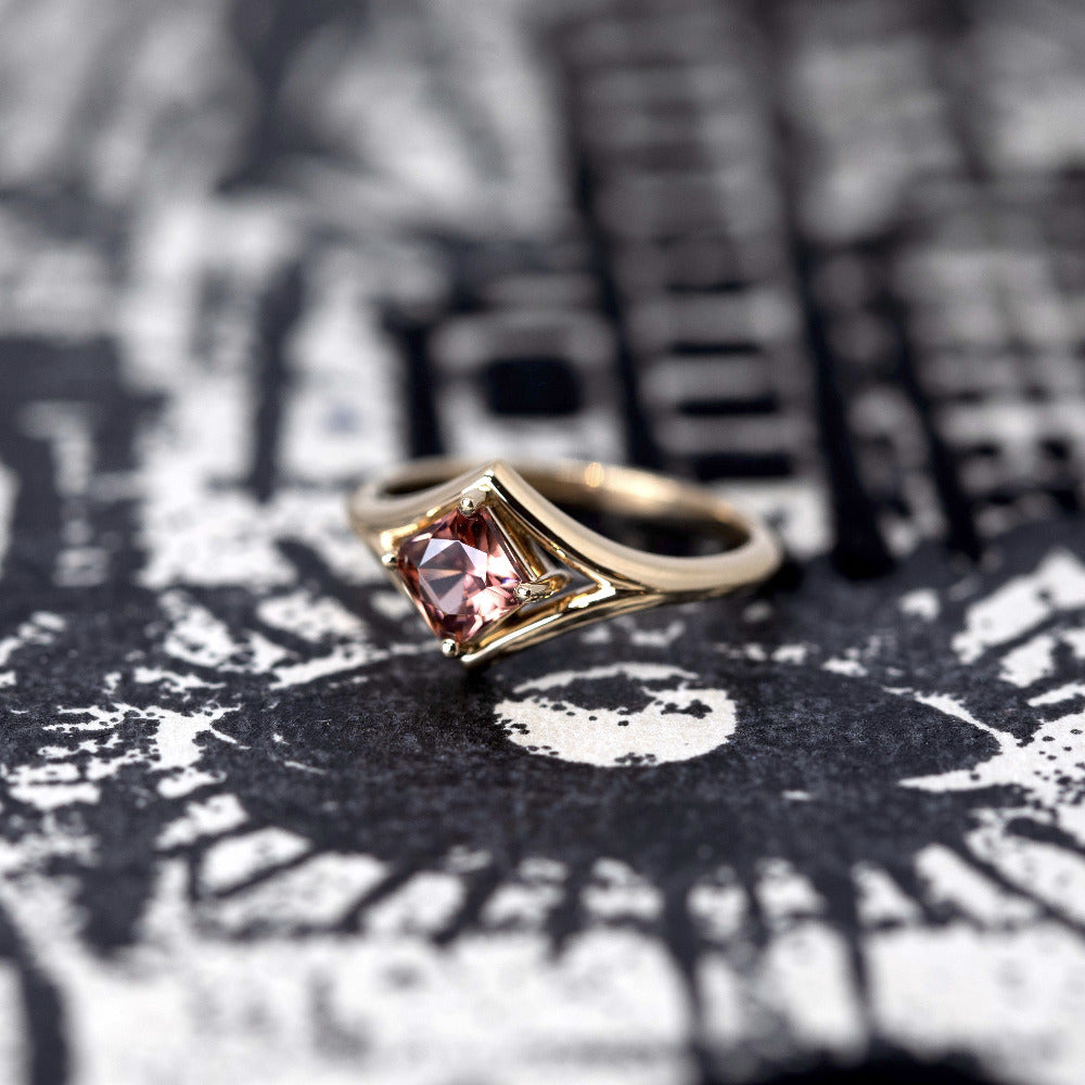 Angled close-up: Focuses on the gemstone’s vibrant peach tones and the smooth finish of the yellow gold band. Designed by Bena Jewelry, an independent jeweler in Montreal, Canada.