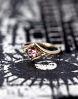 Angled close-up: Focuses on the gemstone’s vibrant peach tones and the smooth finish of the yellow gold band. Designed by Bena Jewelry, an independent jeweler in Montreal, Canada.