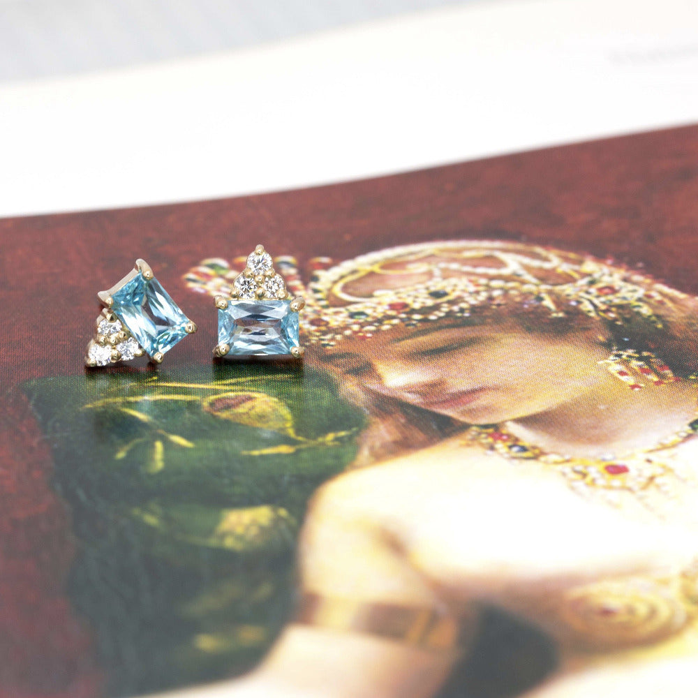 Vibrant yellow gold earrings with bright sky-blue zircons and sparkling diamonds, perfect for a bold statement.