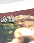 Vibrant yellow gold earrings with bright sky-blue zircons and sparkling diamonds, perfect for a bold statement.