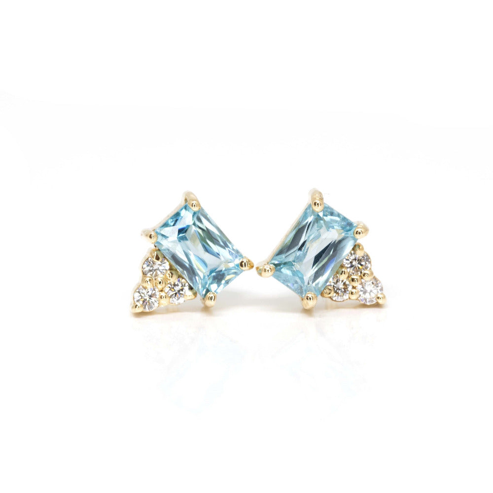 Minimalist design highlighting the emerald-cut zircons and fine diamond accents in a contemporary yellow gold setting.