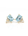 Minimalist design highlighting the emerald-cut zircons and fine diamond accents in a contemporary yellow gold setting.