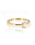 side view of bena jewelry yellow gold edgy ring with baguette shape lab grown diamond made in montreal on white background