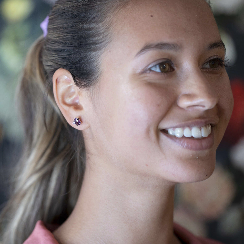 Worn by a model (portrait): A young woman wears the Amethyst & Pink Studs Earrings, demonstrating their elegant proportions and striking gemstone combination.