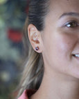 Close-up of earrings worn (lifestyle): Focuses on the earrings in a natural setting, highlighting their bold yet refined aesthetic.