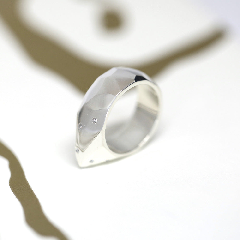 Close-up of the Alp Ring, revealing its sculptural form and refined diamond accents. A striking yet elegant unisex design by Bena Jewelry.