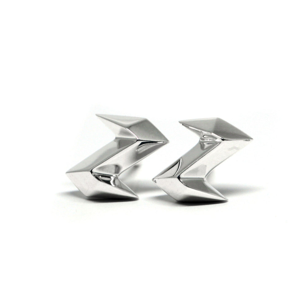 Close-up of Electric Stud Earrings – Bold and minimalist gold studs featuring a striking, sharp silhouette for a contemporary look.