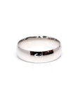 Minimalist white gold domed wedding band, crafted by Bena Jewelry in Montreal, offering a sophisticated and timeless look for modern weddings.