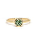 Bena Jewelry’s Bezel Set Demantoide Ring, crafted in yellow gold with a bezel-set green garnet, displayed on a white background. Made in Canada.