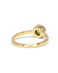 Bezel Set Demantoide Ring in yellow gold, showcasing a round-cut green garnet, crafted by Bena Jewelry. Photographed on a white background, custom-made in Montreal.