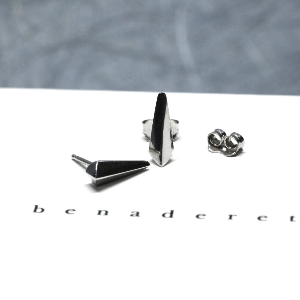 Blade stud earrings in white gold by Bena Jewelry, presented on a bright texture background. Made in Montreal, Canada.