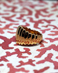 Side shot of Pigalle Ring in Yellow Gold – A highly detailed close-up showcasing the precision craftsmanship and bold ridged design.