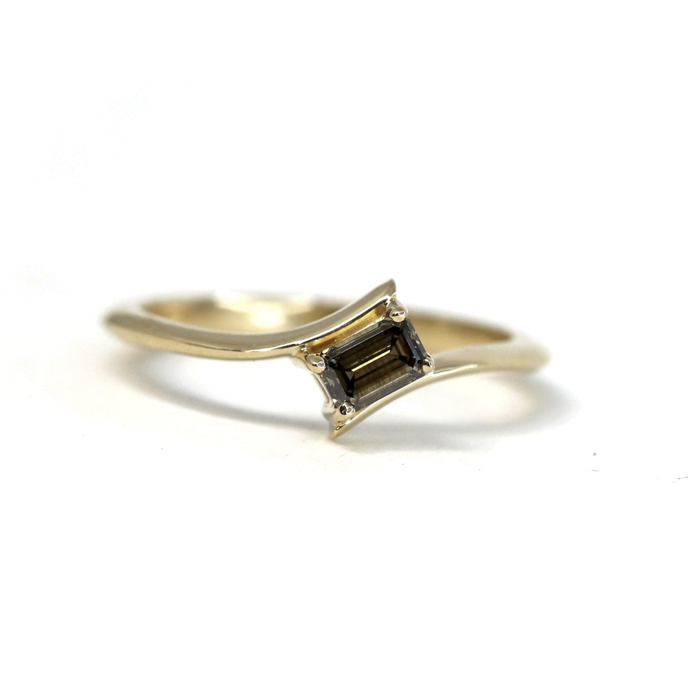 Unique yellow gold ring with a twisted band and chocolate diamond Kink Baguette Ring by Bena Jewelry displayed on a plain white background fine jewelry made in Canada.