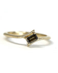 Unique yellow gold ring with a twisted band and chocolate diamond Kink Baguette Ring by Bena Jewelry displayed on a plain white background fine jewelry made in Canada.
