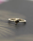Kink Baguette Chocolat Diamond Ring in yellow gold featuring a twisted band and a baguette-cut chocolate diamond by Bena Jewelry photographed on a dark background.