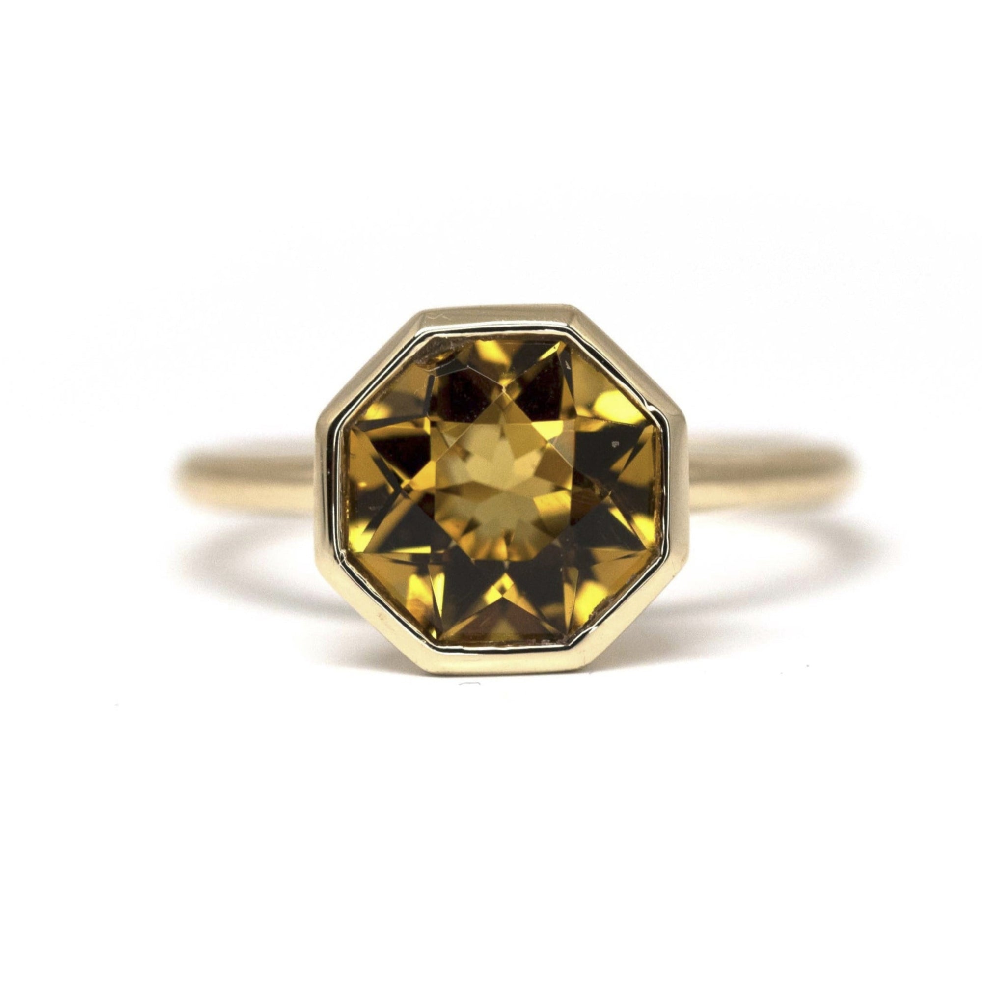 Hexagonal Fireball Citrine ring on white background – Bold cocktail ring featuring a vibrant hexagonal Brazilian citrine, bezel-set in yellow gold. Designed by Bena Jewelry in Montreal.