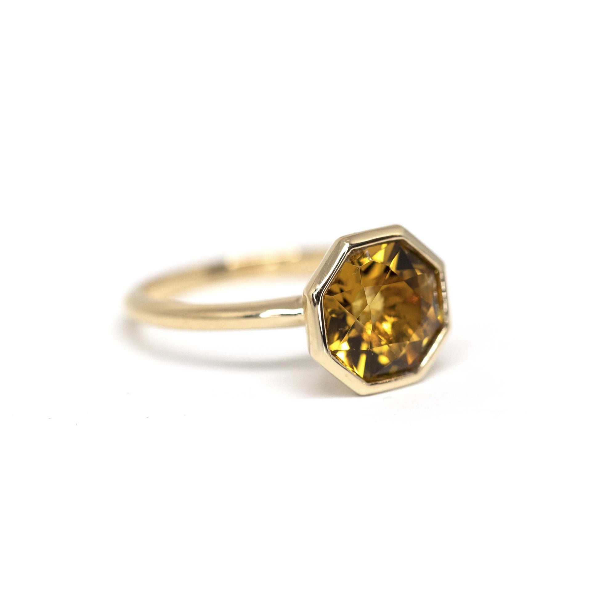 Side view of Hexagonal Fireball Citrine ring – Elegant gold bezel setting highlighting the deep golden hues of the Brazilian citrine. A unique design by Bena Jewelry, Montreal.