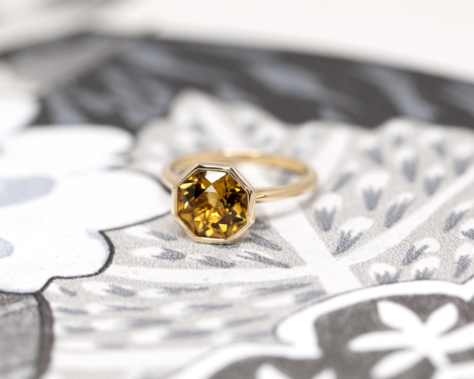 Fireball Citrine ring styled in natural light – Warm golden hues of the Brazilian citrine glowing under sunlight, set in a sleek yellow gold bezel. A one-of-a-kind piece by Bena Jewelry.