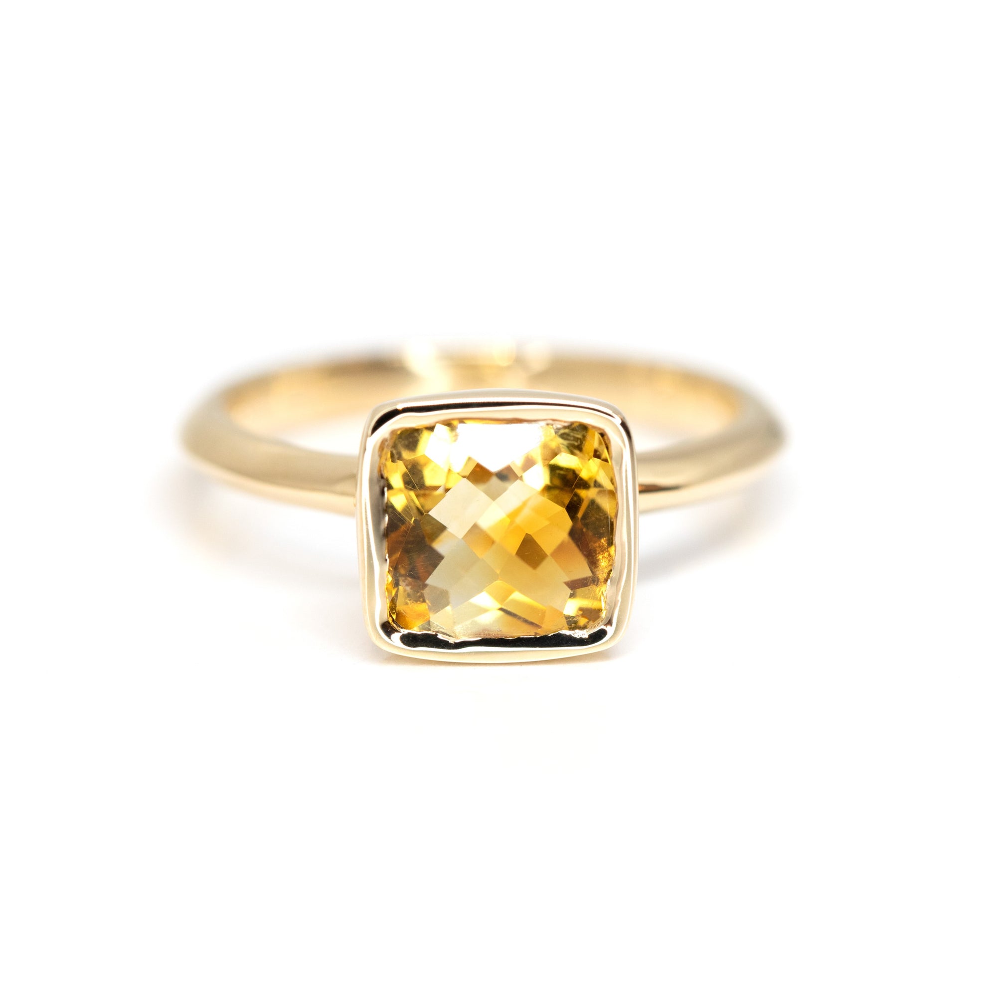 Front view of the Bezel Set Citrine ring, crafted by Bena Jewelry in Montreal, Canada, showcasing the vibrant yellow-orange natural citrine in its sleek bezel setting.