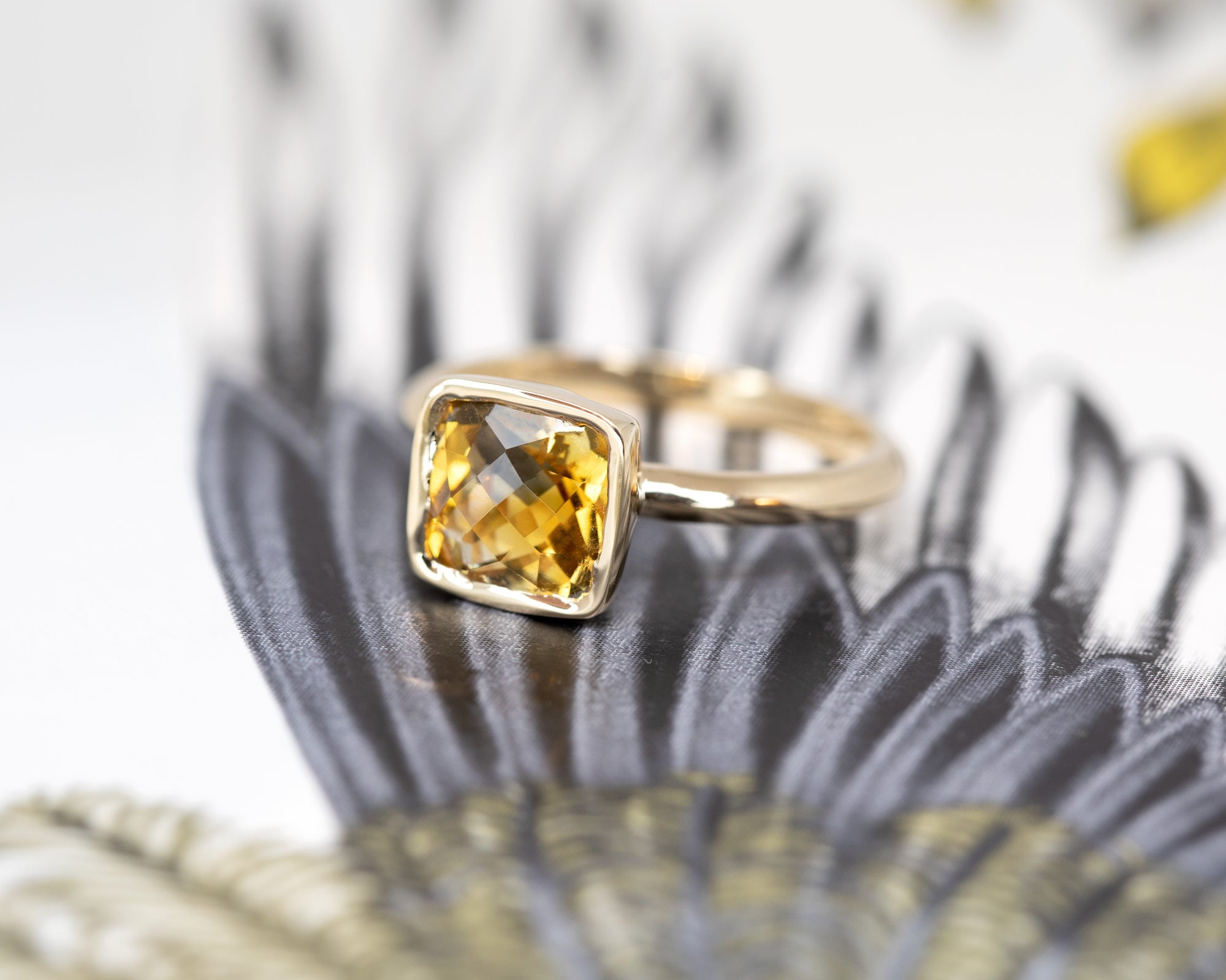 Side angle of the ring, highlighting the elegant yellow gold band and the secure bezel setting of the Brazilian citrine gemstone. Fine jewelry made in Canada.