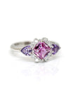 front view of purple and pink sapphire square shape and trillon cut gemstone with extra bright round diamond custom made in montreal by bena jewelry at ruby mardi on a white background