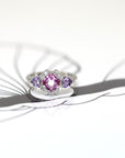 front view square shape pink sapphire and trillon shape purple gemstone diamond platinum custom made ring on white background