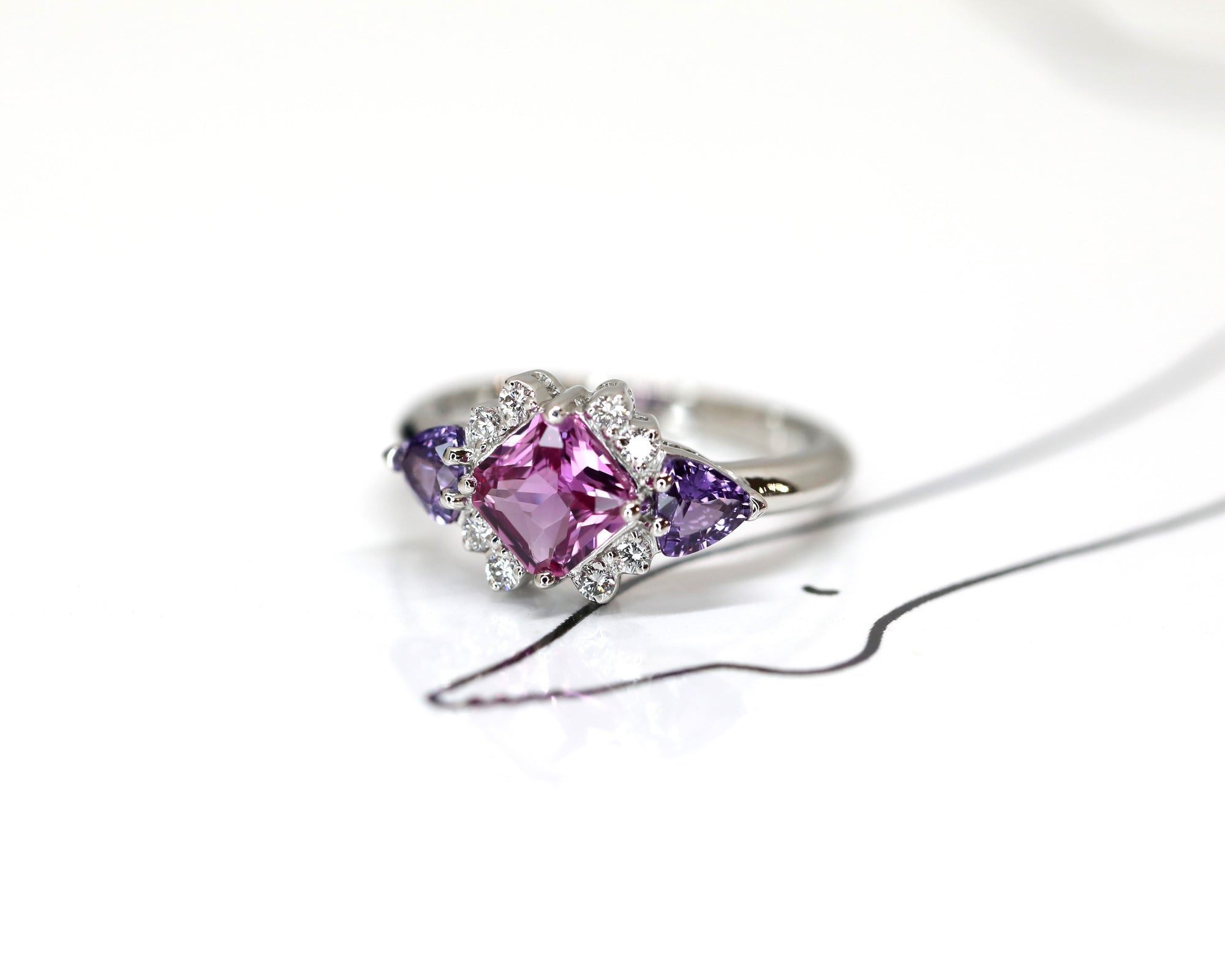 side view of square pink sapphire purple trillon gems and diamond custom made in montreal at the best jeweler ruby mardi by the designer bena jewelry on white background