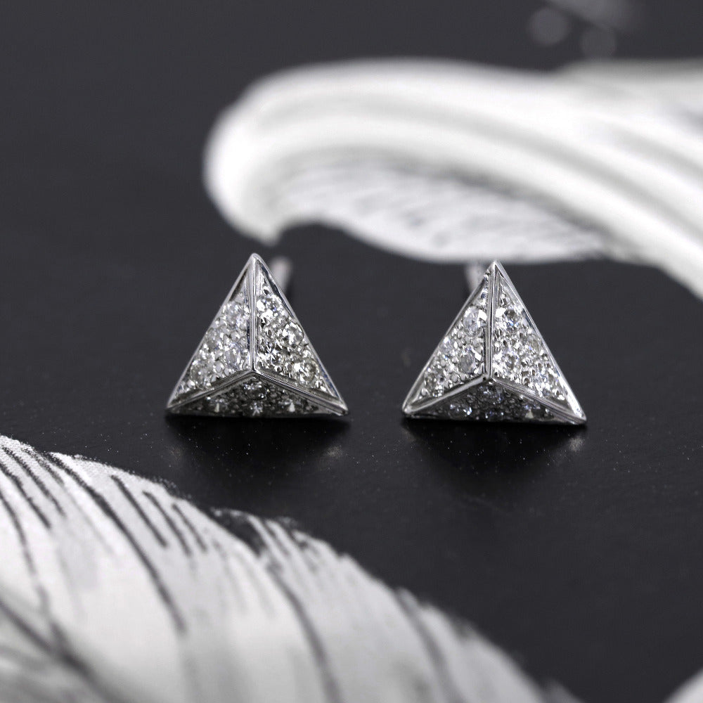 Front view of Delta earrings displaying the earring's secure clasp and flawless craftsmanship. Focusing on the diamonds' brilliance and the polished finish of the gold.