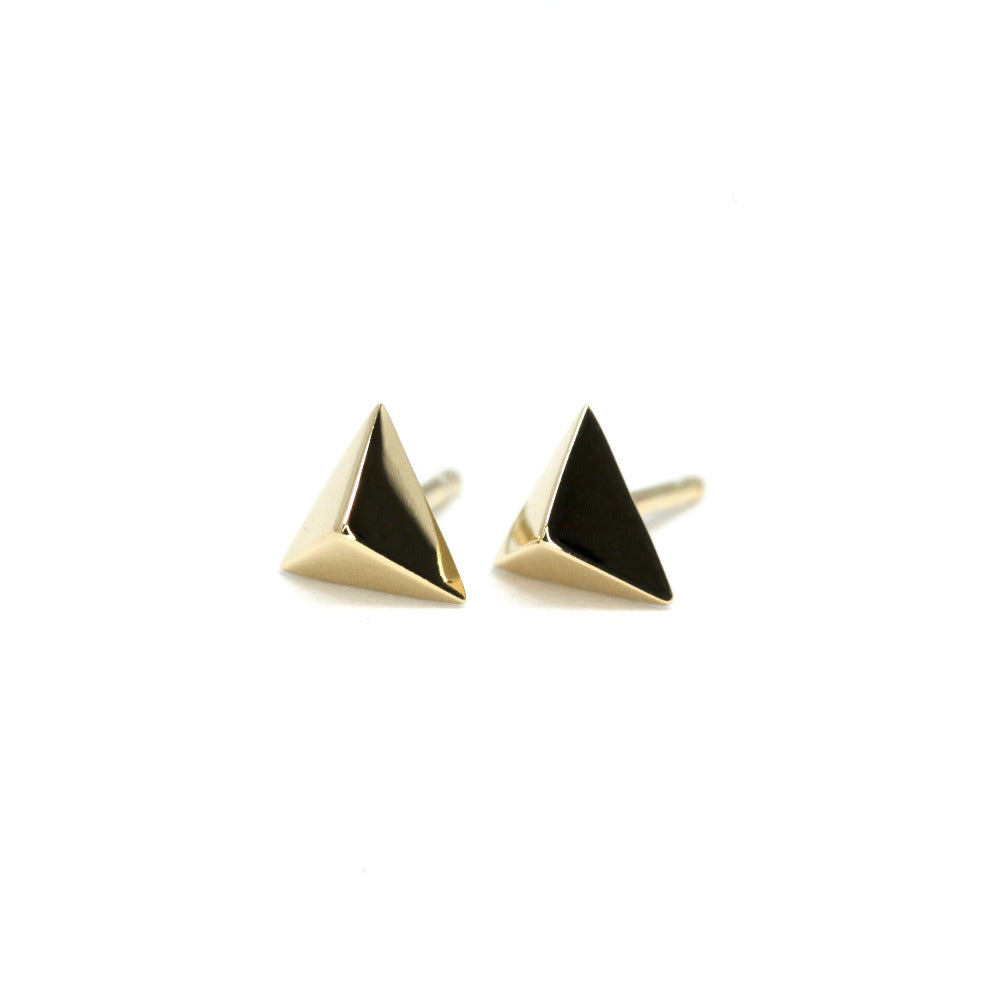Bold yellow gold Delta Gold Studs with a sharp geometric design, crafted by Bena Jewelry, photographed on a white background, contemporary unisex jewelry.