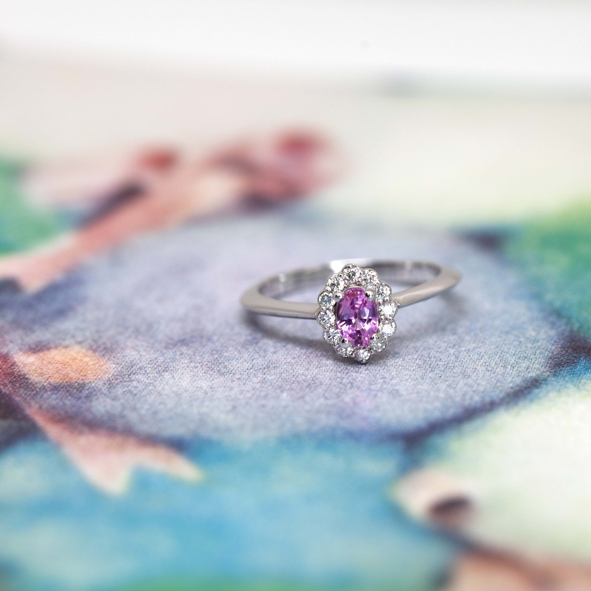 Elegant Diamond Halo Ring featuring a pink sapphire in white gold, custom-made by Bena Jewelry with natural gemstones, perfect for bridal occasions.