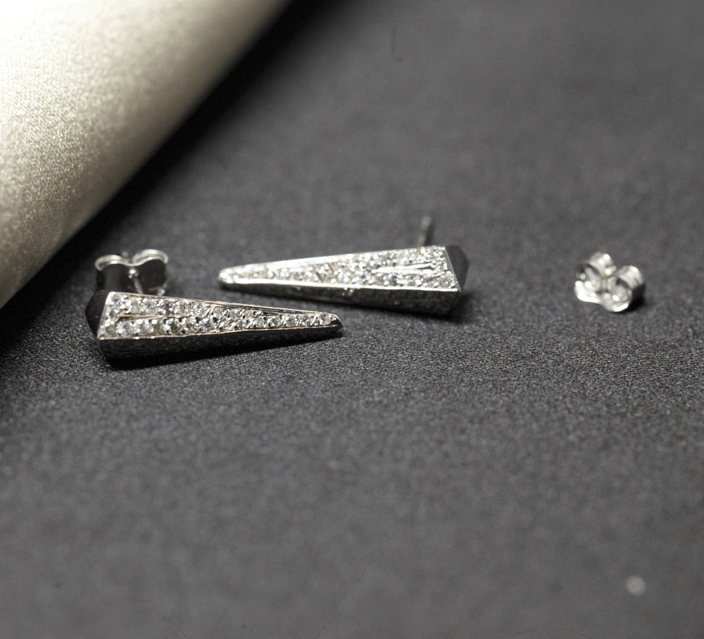 Close-up of diamond earrings – A refined blend of contemporary luxury and bold design, featuring natural diamonds in a sleek white gold setting.