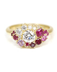 The Avalanche Ruby, Sapphire & Diamond Ring, highlighting its central diamond and striking rubies in polished yellow gold. Created by Bena Jewelry in Montreal, Canada.