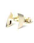 Minimalist fine jewelry: yellow gold Brace Studs with a sharp, edgy center line, designed in Montreal.