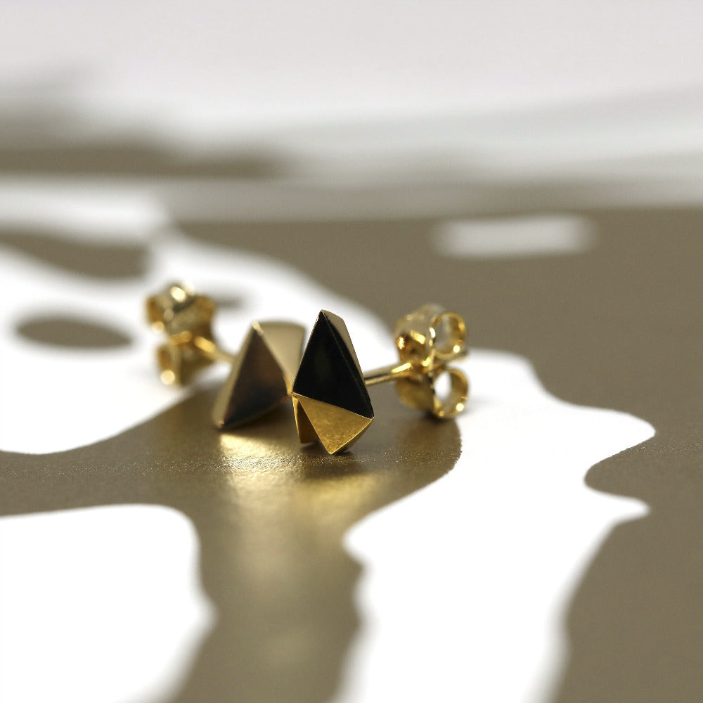White gold heart-shaped stud earrings with a bold design, Edgy Gold Heart Studs by Bena Jewelry, displayed on a white background, custom fine jewelry crafted in Canada.