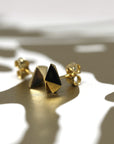White gold heart-shaped stud earrings with a bold design, Edgy Gold Heart Studs by Bena Jewelry, displayed on a white background, custom fine jewelry crafted in Canada.