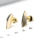 Vibrant display of the Brace Studs in yellow gold, a modern creation by an independent jewelry designer in Montreal.
