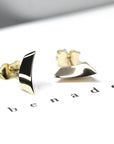 Minimalist earrings in yellow gold with a sharp, volumetric design for a striking play of light.