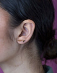Girl wearings sharp and modern: the Brace Studs in yellow gold bring edgy sophistication to any look. Indenpandant designer jewelry, from Canada.