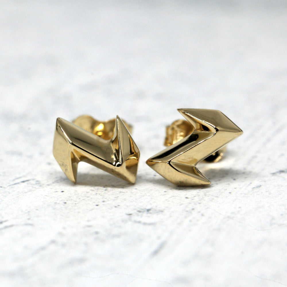 Electric Stud Earrings on soft-toned background – The sharp electric-inspired shape stands out beautifully against a neutral backdrop.