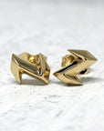 Electric Stud Earrings on soft-toned background – The sharp electric-inspired shape stands out beautifully against a neutral backdrop.