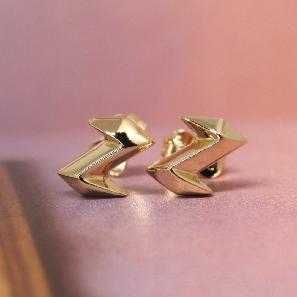 Angled shot of Electric Edgy Studs – A sharp, high-polish gold earring design perfect for those who love sleek, statement jewelry.