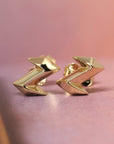 Angled shot of Electric Edgy Studs – A sharp, high-polish gold earring design perfect for those who love sleek, statement jewelry.