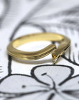 Top-down view of Kink Ring in Yellow Gold – A unique designer ring featuring a curved gold line and an open structure.