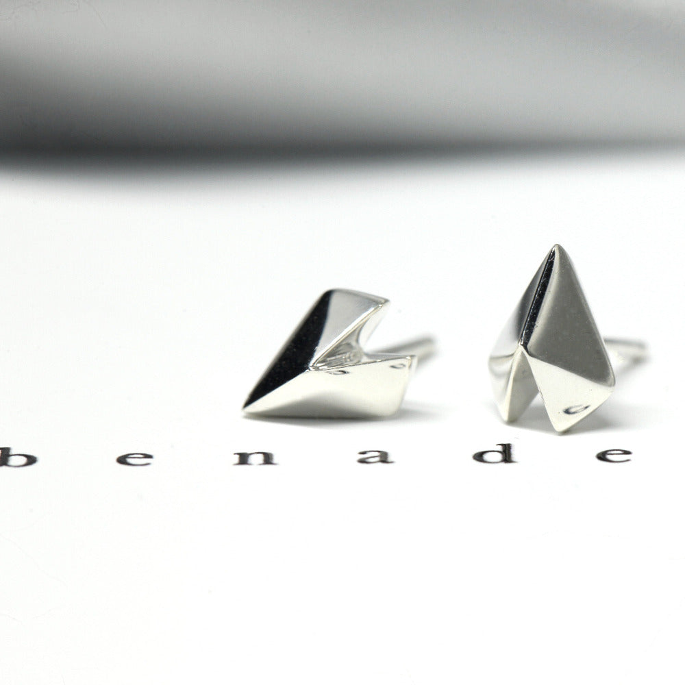 Edgy Gold Heart Studs in white gold by Bena Jewelry, featuring a geometric heart design, photographed on a soft pastel background, modern unisex jewelry custom-made in Montreal.